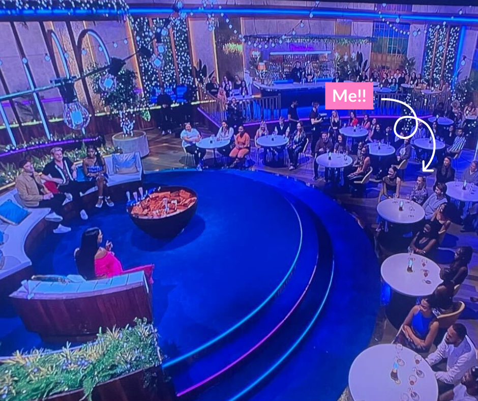 Annie sat in the audience of Love Island: Aftersun with an arrow pointing to her saying 'Me!!'